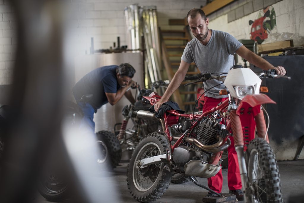 two mechanics in motorcycle workshop enduro suspensions