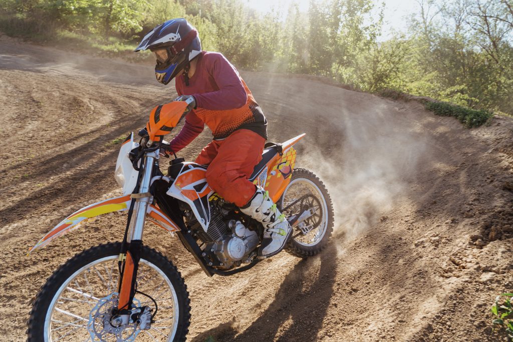 motocyclist rider on motocross track ride downhill bike