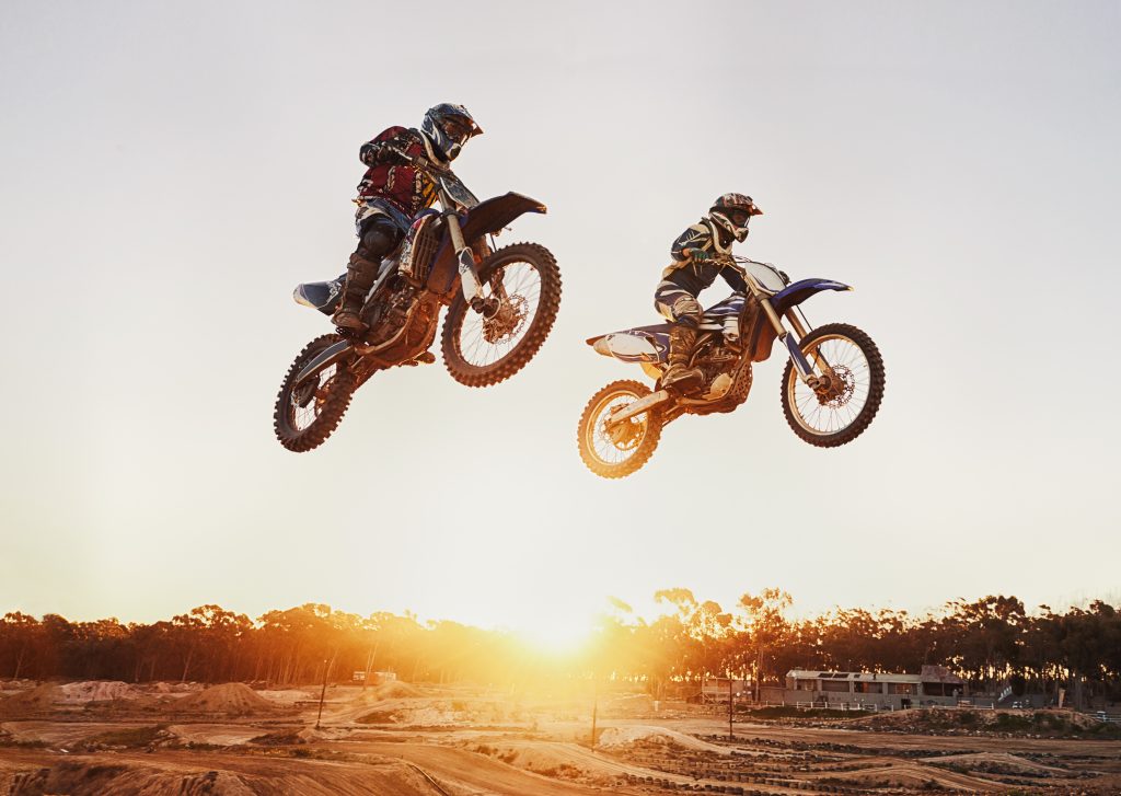 motocross riders performing jumps